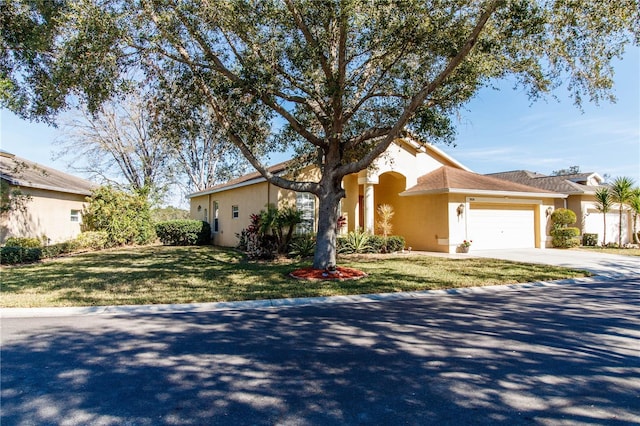 view of front of home with a garage and a front yard