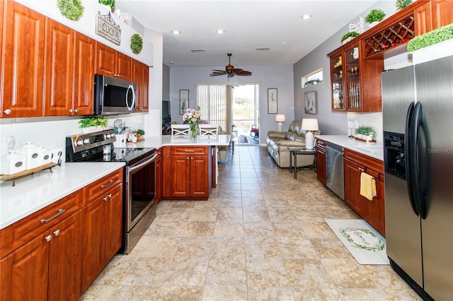 kitchen featuring kitchen peninsula, ceiling fan, and appliances with stainless steel finishes