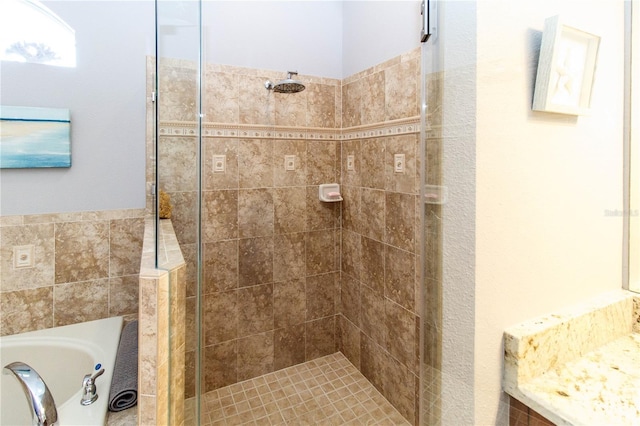 bathroom featuring shower with separate bathtub