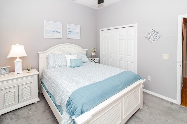 carpeted bedroom with ceiling fan and a closet