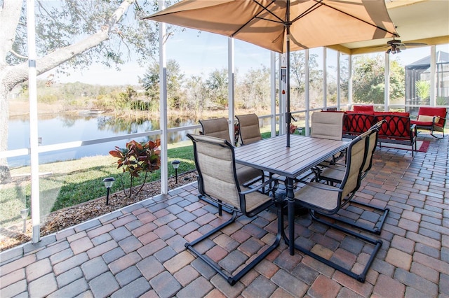 view of patio with an outdoor living space, ceiling fan, and a water view