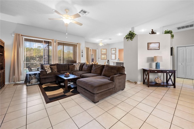 tiled living room with ceiling fan