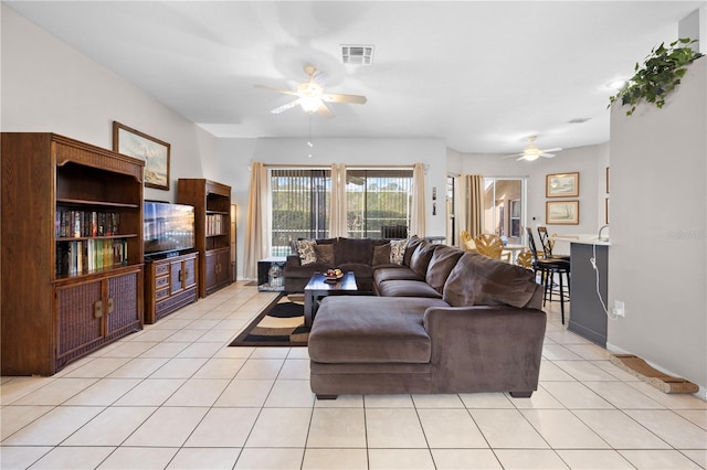 living room with ceiling fan and light tile patterned floors