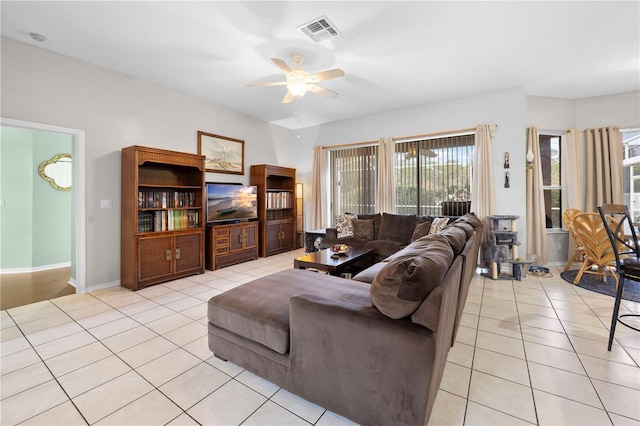 living room featuring light tile patterned flooring and ceiling fan