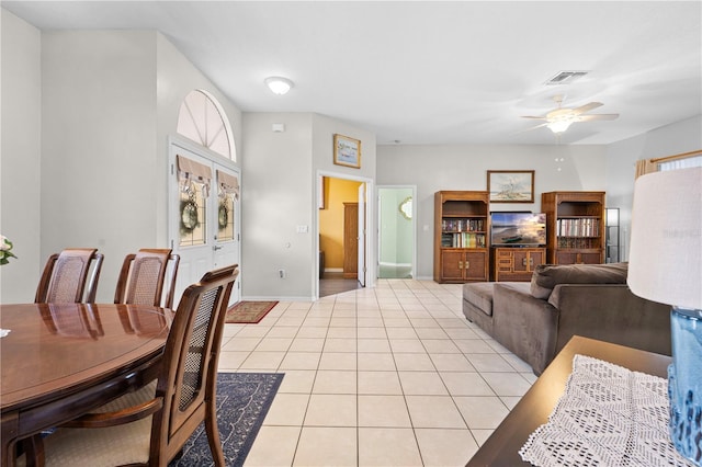 tiled living room with ceiling fan