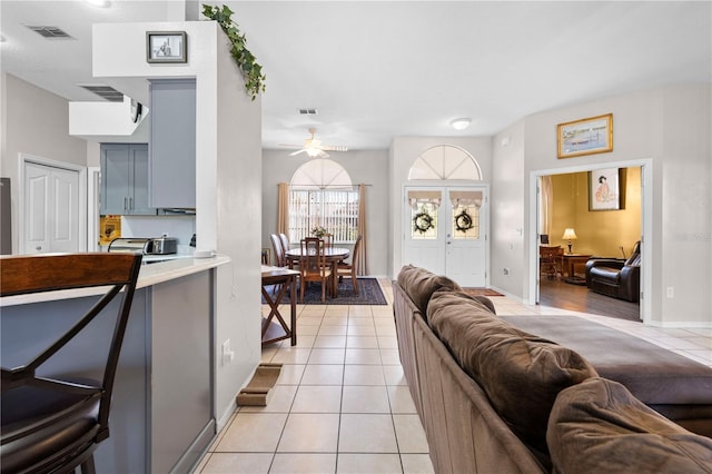 tiled living room with ceiling fan