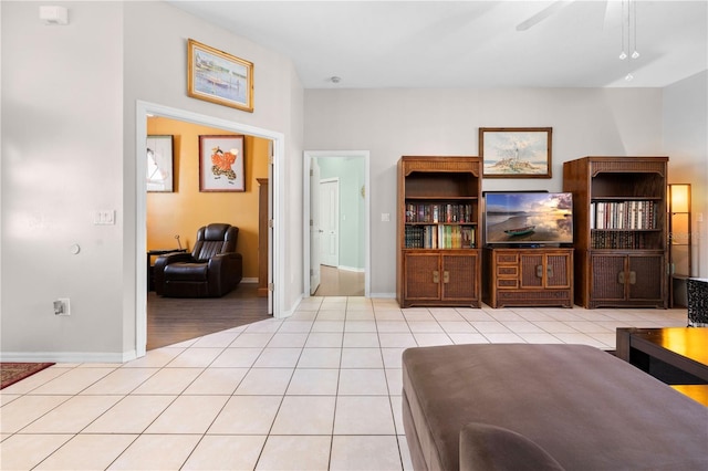 tiled living room featuring ceiling fan