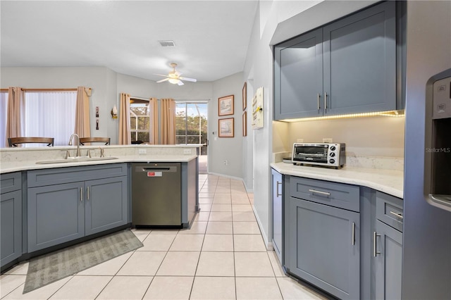 kitchen featuring sink, light tile patterned floors, ceiling fan, gray cabinetry, and stainless steel appliances