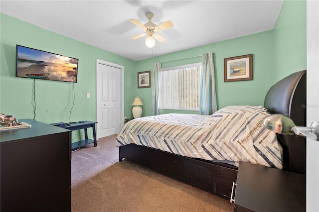 carpeted bedroom featuring a closet and ceiling fan