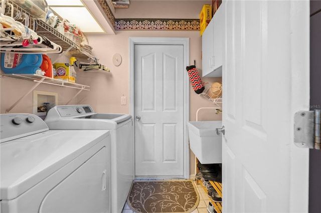 washroom featuring cabinets, tile patterned floors, and washer and clothes dryer