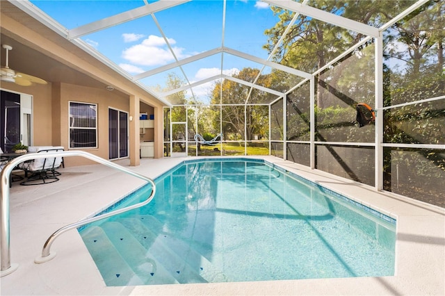 view of swimming pool with a lanai and a patio