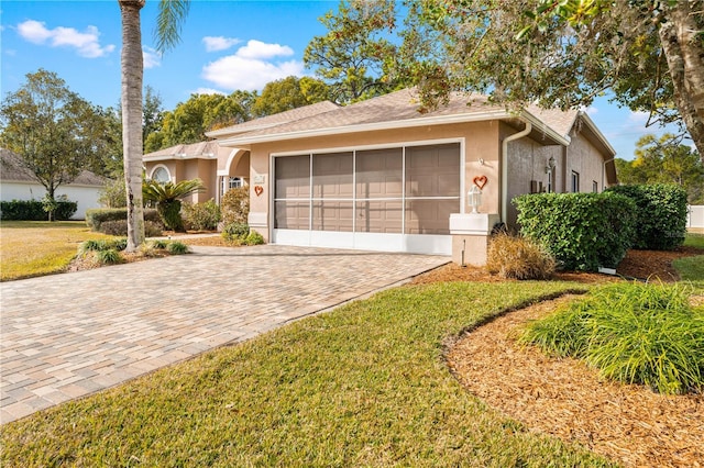 ranch-style home featuring a garage and a front yard