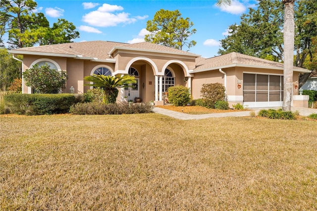 view of front of property with a front lawn and a sunroom