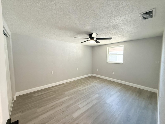 unfurnished room featuring hardwood / wood-style flooring, a textured ceiling, and ceiling fan