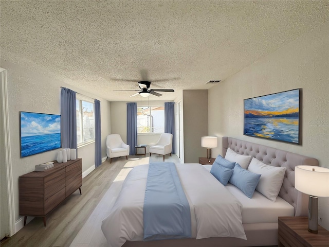 bedroom featuring ceiling fan, light hardwood / wood-style flooring, and a textured ceiling