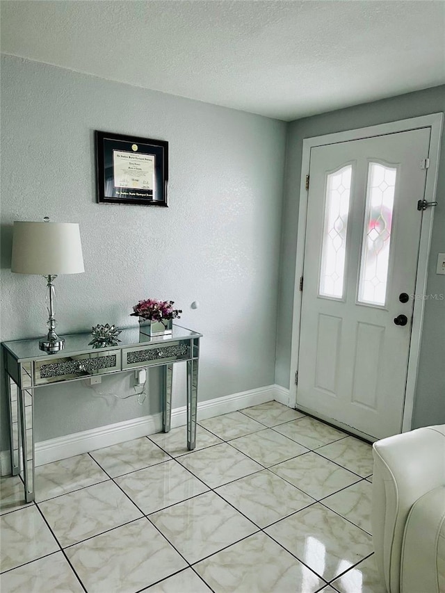 entryway with a textured ceiling