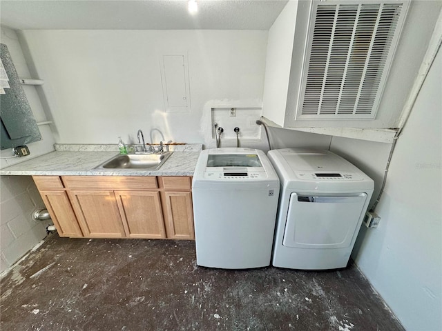 laundry room with cabinets, sink, and washer and clothes dryer