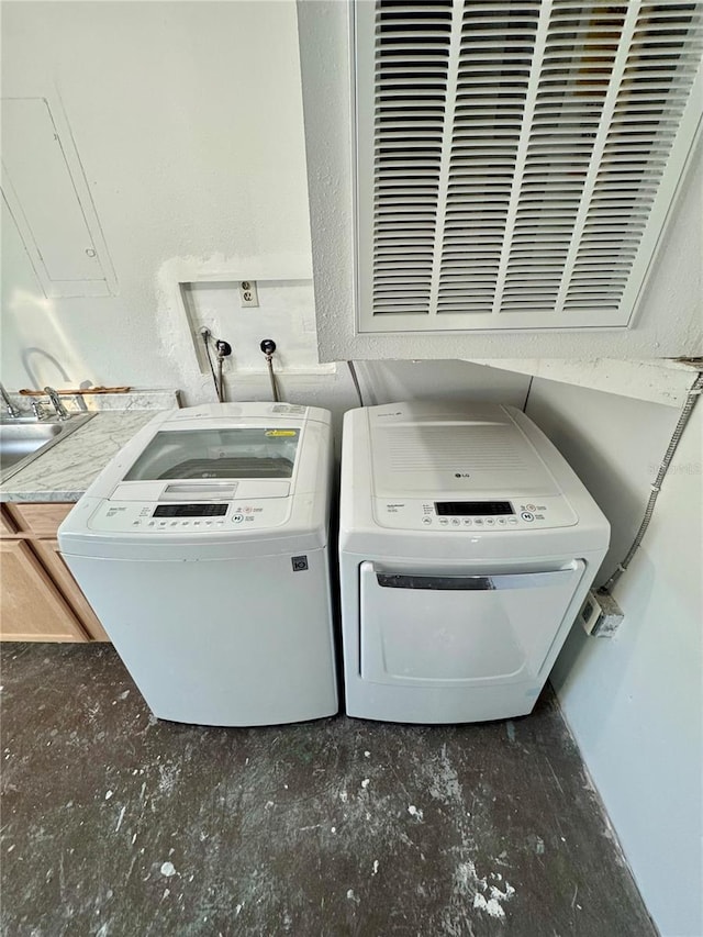 washroom with sink and washing machine and clothes dryer