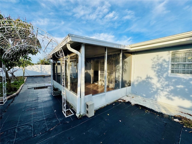 view of side of home with a sunroom