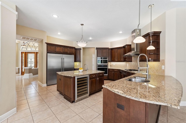 kitchen featuring dark brown cabinets, stainless steel appliances, wine cooler, decorative light fixtures, and kitchen peninsula