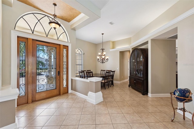 foyer featuring light tile patterned flooring and a chandelier