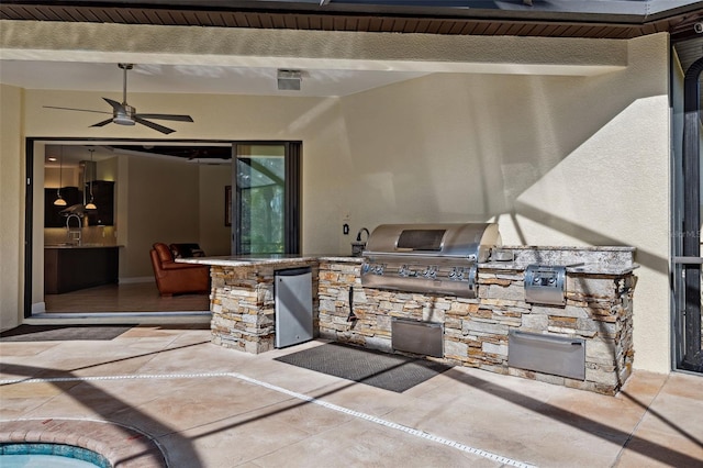 view of patio featuring ceiling fan, area for grilling, a grill, and sink