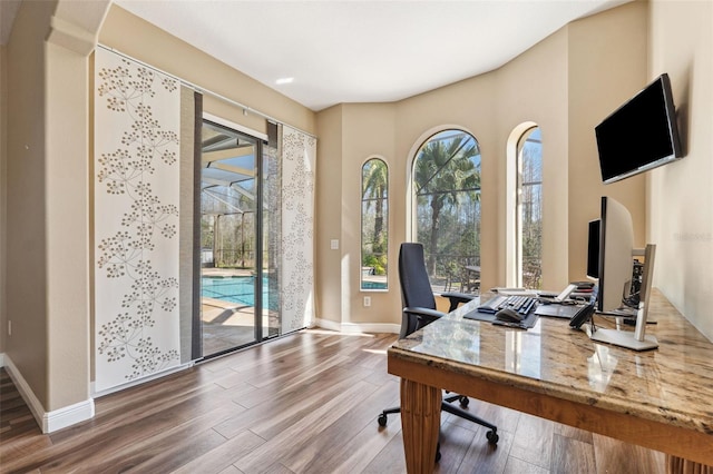 office area with a healthy amount of sunlight and hardwood / wood-style floors