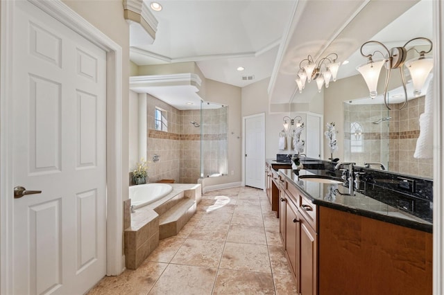 bathroom featuring tile patterned flooring, vanity, separate shower and tub, and a notable chandelier