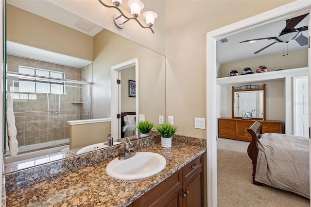 bathroom with ceiling fan, vanity, and a shower with shower door