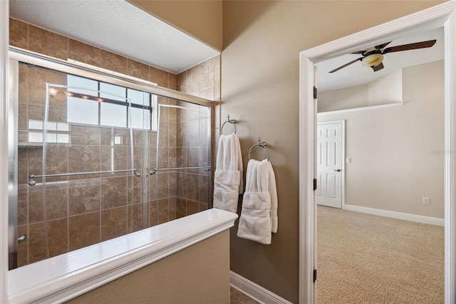 bathroom with an enclosed shower and ceiling fan