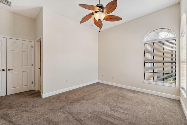 carpeted empty room with ceiling fan