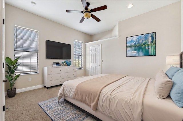 bedroom featuring light colored carpet and ceiling fan