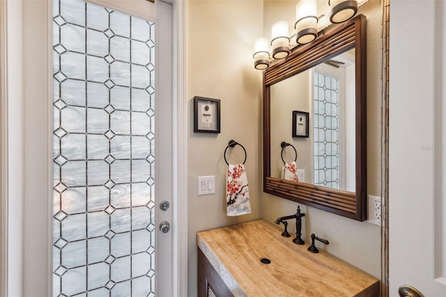 bathroom featuring vanity and a notable chandelier