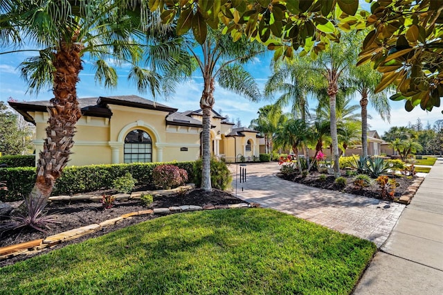 mediterranean / spanish house with a front lawn