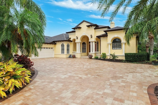 20200 Lace Cascade Rd, Land O Lakes, FL 34637 - view of front of home with stucco siding, a garage, and decorative driveway