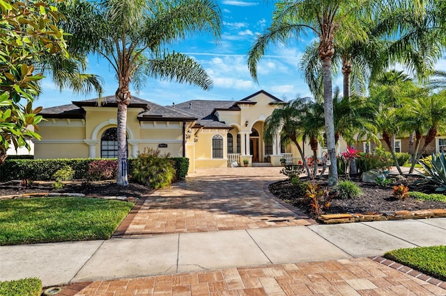 20200 Lace Cascade Rd, Land O Lakes, FL 34637 - mediterranean / spanish house featuring stucco siding and decorative driveway
