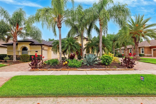 20200 Lace Cascade Rd, Land O Lakes, FL 34637 - mediterranean / spanish-style house featuring decorative driveway, stucco siding, and a front yard
