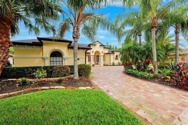 20200 Lace Cascade Rd, Land O Lakes, FL 34637 - mediterranean / spanish-style house with stucco siding and decorative driveway