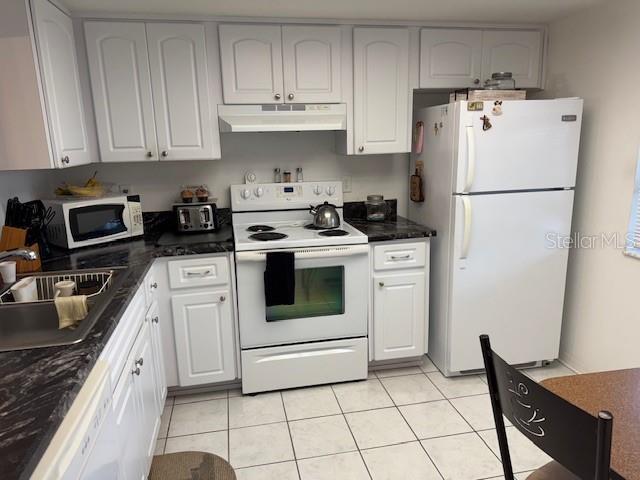 kitchen featuring white cabinetry, white appliances, and sink