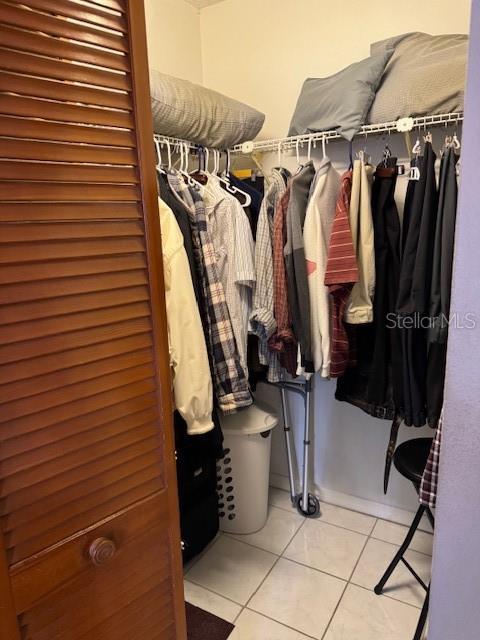 spacious closet featuring light tile patterned floors