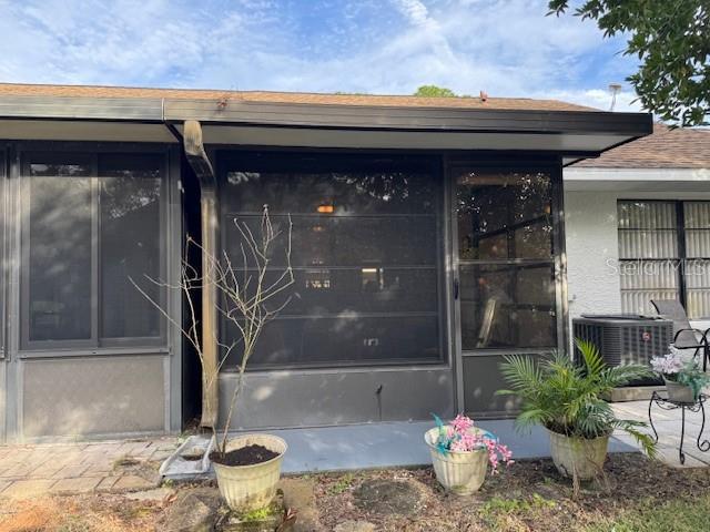 property entrance with central AC unit