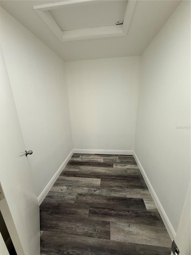 interior space featuring a tray ceiling and dark hardwood / wood-style flooring