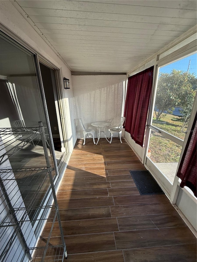 unfurnished sunroom featuring wooden ceiling