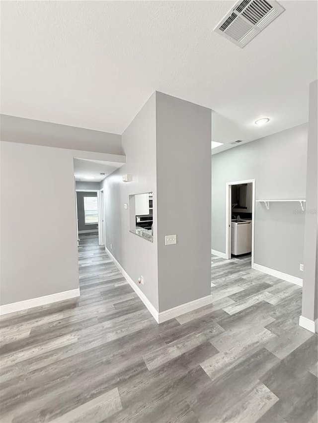 4218 San Rafael Ave, New Port Richey, FL 34655 - hallway with baseboards, visible vents, and wood finished floors