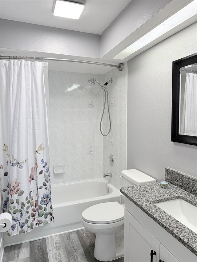 4218 San Rafael Ave, New Port Richey, FL 34655 - bathroom with toilet, wood finished floors, vanity, and shower / bathtub combination with curtain