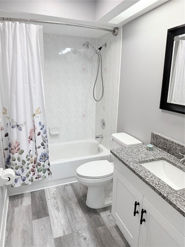 4218 San Rafael Ave, New Port Richey, FL 34655 - full bath featuring toilet, wood finished floors, vanity, and shower / bath combo with shower curtain