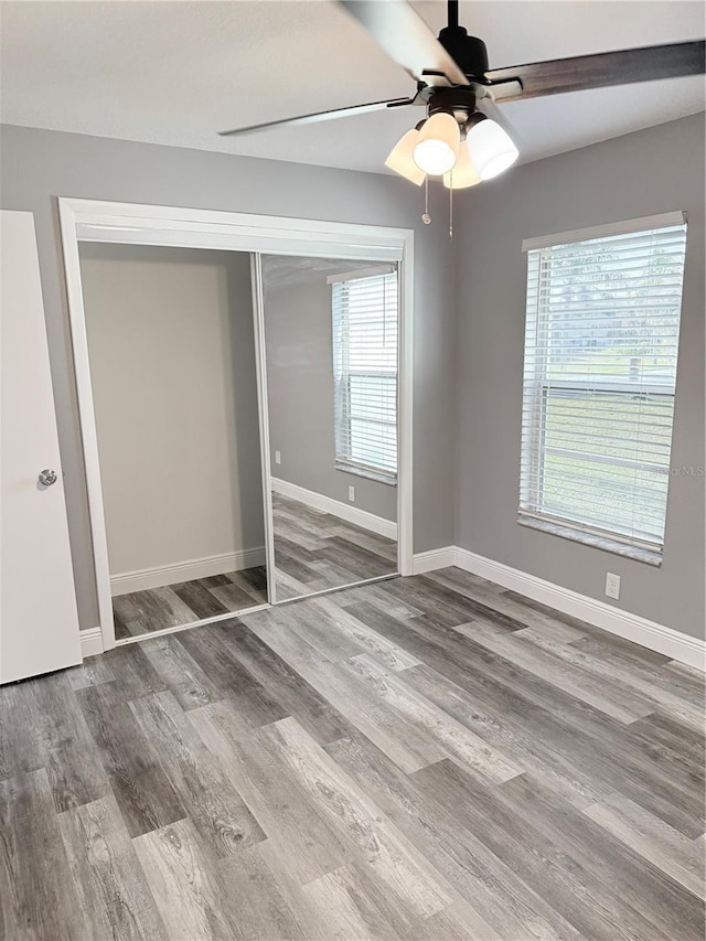 4218 San Rafael Ave, New Port Richey, FL 34655 - unfurnished bedroom featuring baseboards, ceiling fan, wood finished floors, and a closet
