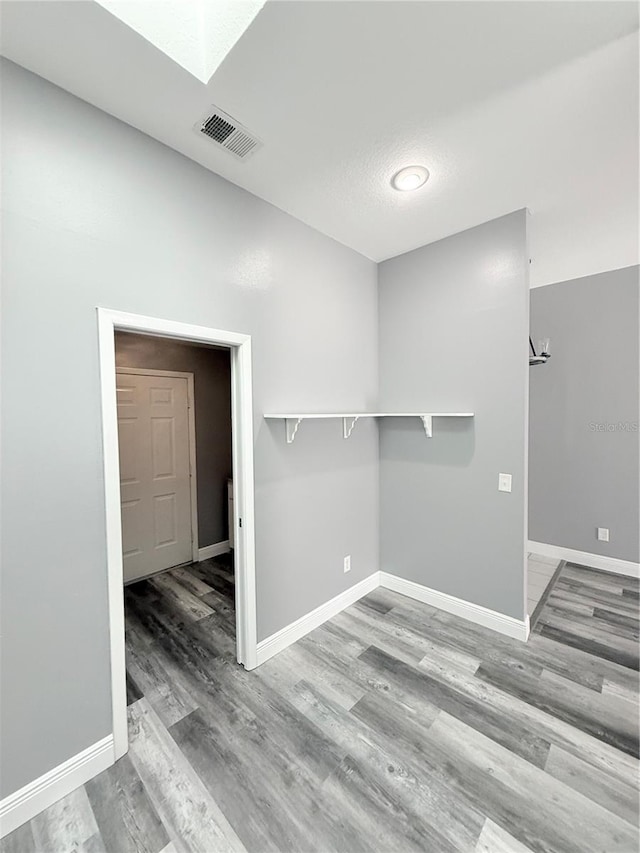 4218 San Rafael Ave, New Port Richey, FL 34655 - spare room with baseboards, visible vents, wood finished floors, and a skylight