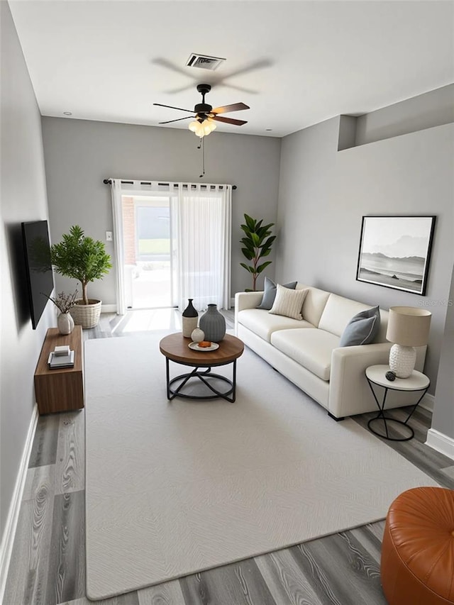 4218 San Rafael Ave, New Port Richey, FL 34655 - living area featuring a ceiling fan, wood finished floors, and baseboards