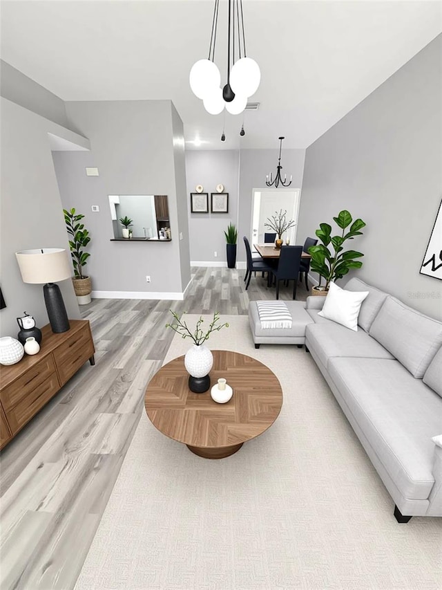 4218 San Rafael Ave, New Port Richey, FL 34655 - living area with a chandelier, light wood finished floors, and baseboards